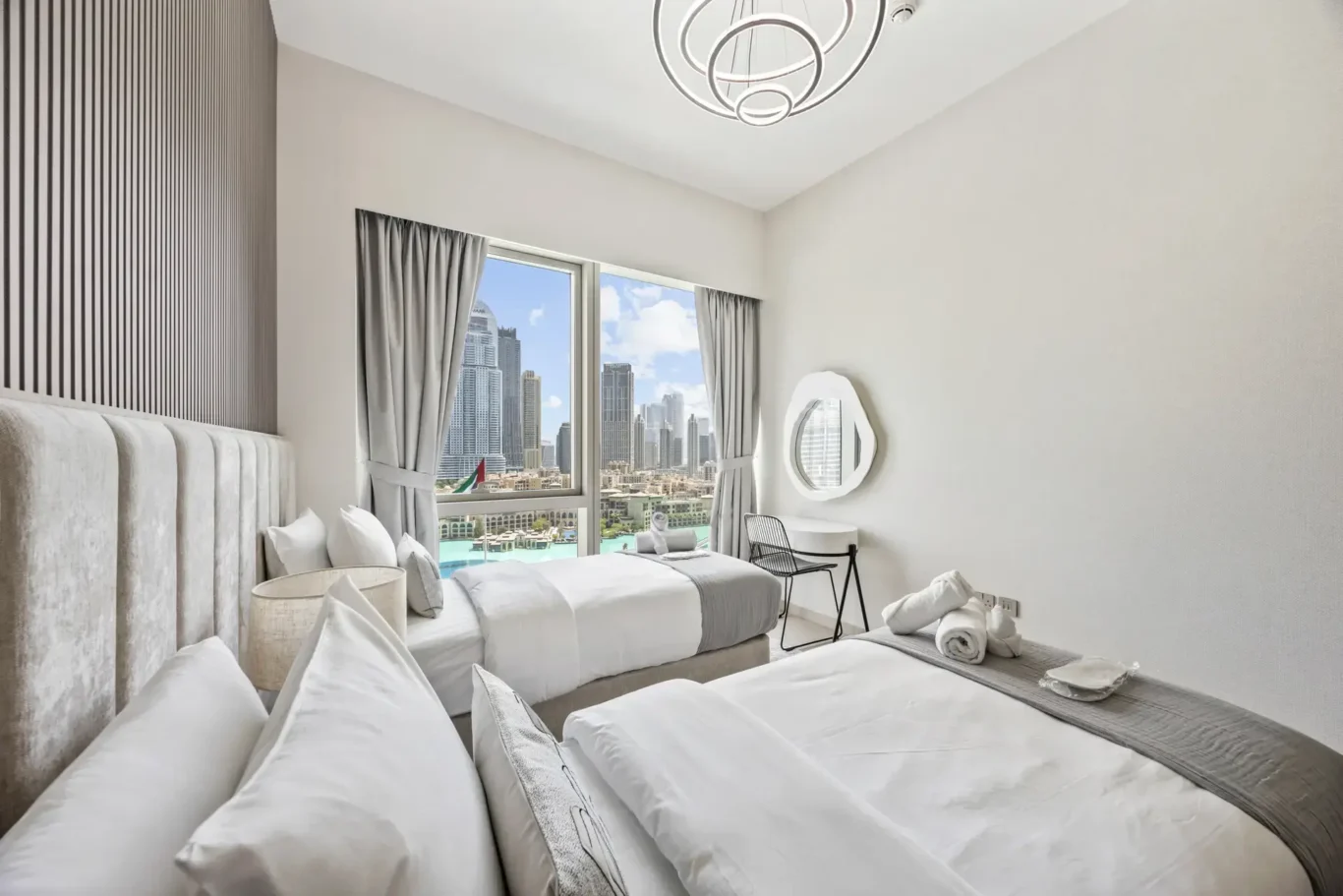 Twin bedroom with skyline view in a two-bedroom StayComfy Holiday Homes apartment at Grande Signature, Downtown Dubai.