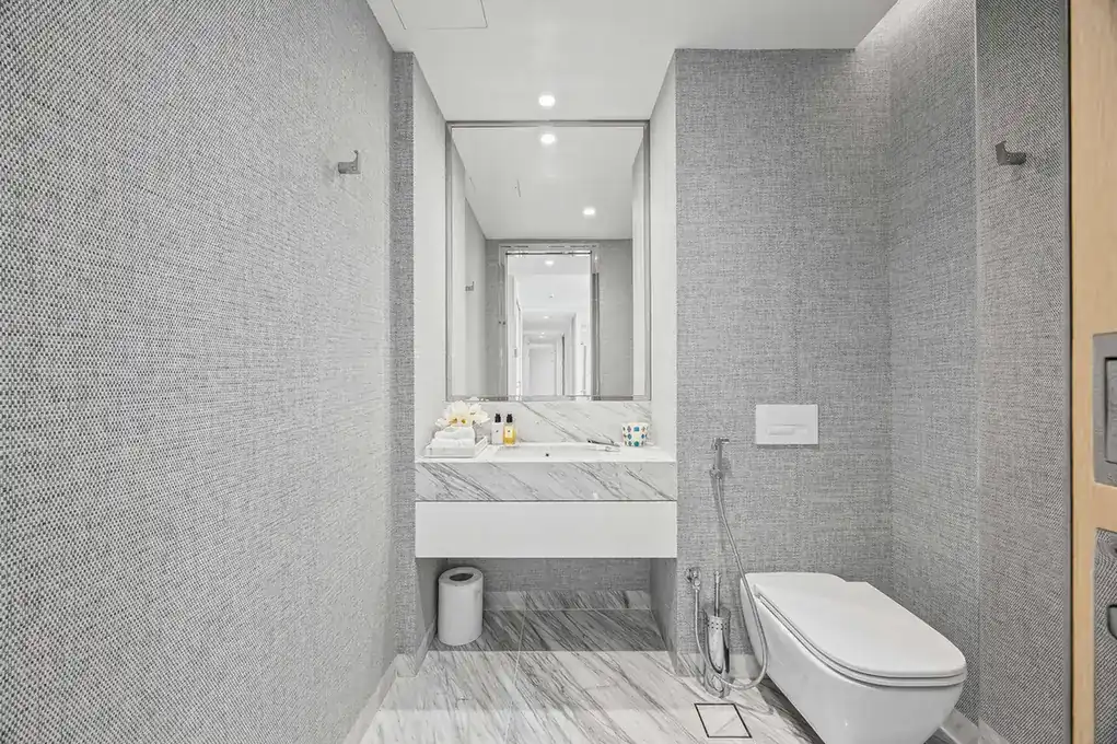Guest powder room with marble vanity in a furnished three-bedroom residence at Atlantis The Royal, Palm Jumeirah, photographed for Apex Homes Real Estate.