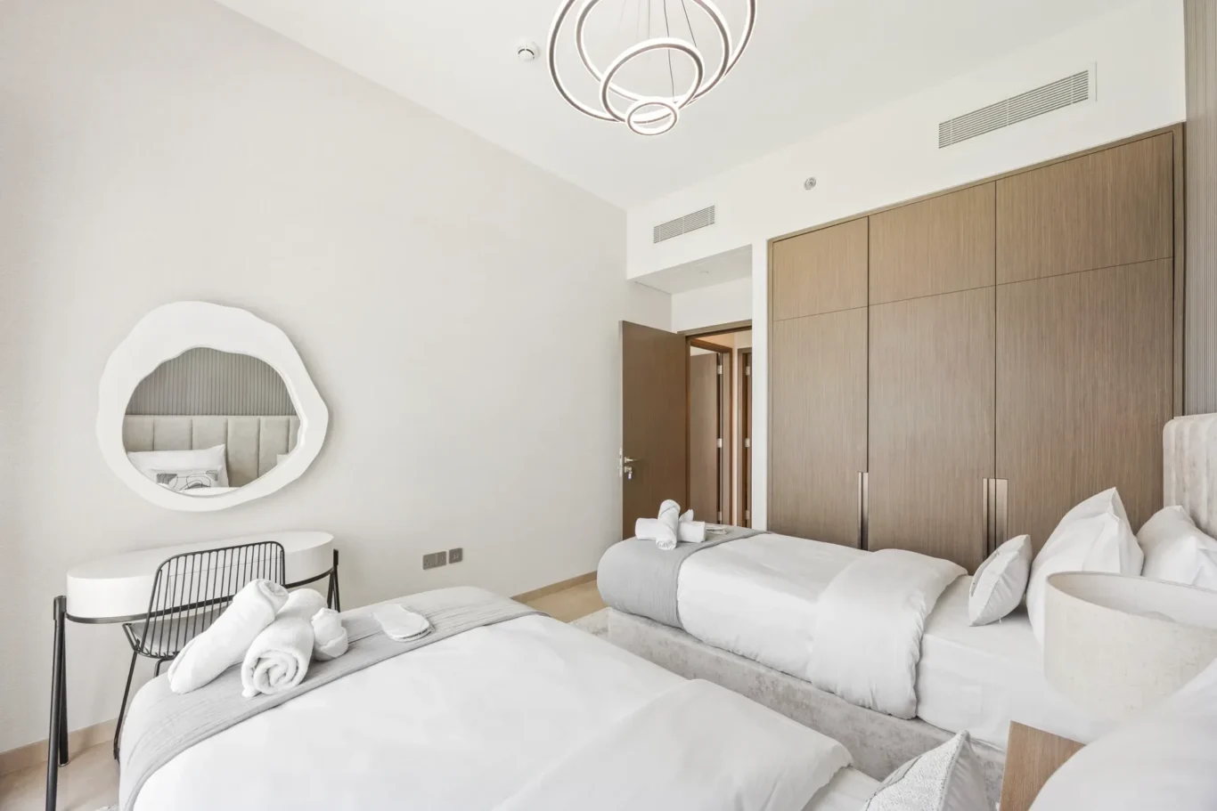 Twin bedroom with fitted wardrobe in a two-bedroom StayComfy Holiday Homes apartment at Grande Signature, Downtown Dubai.