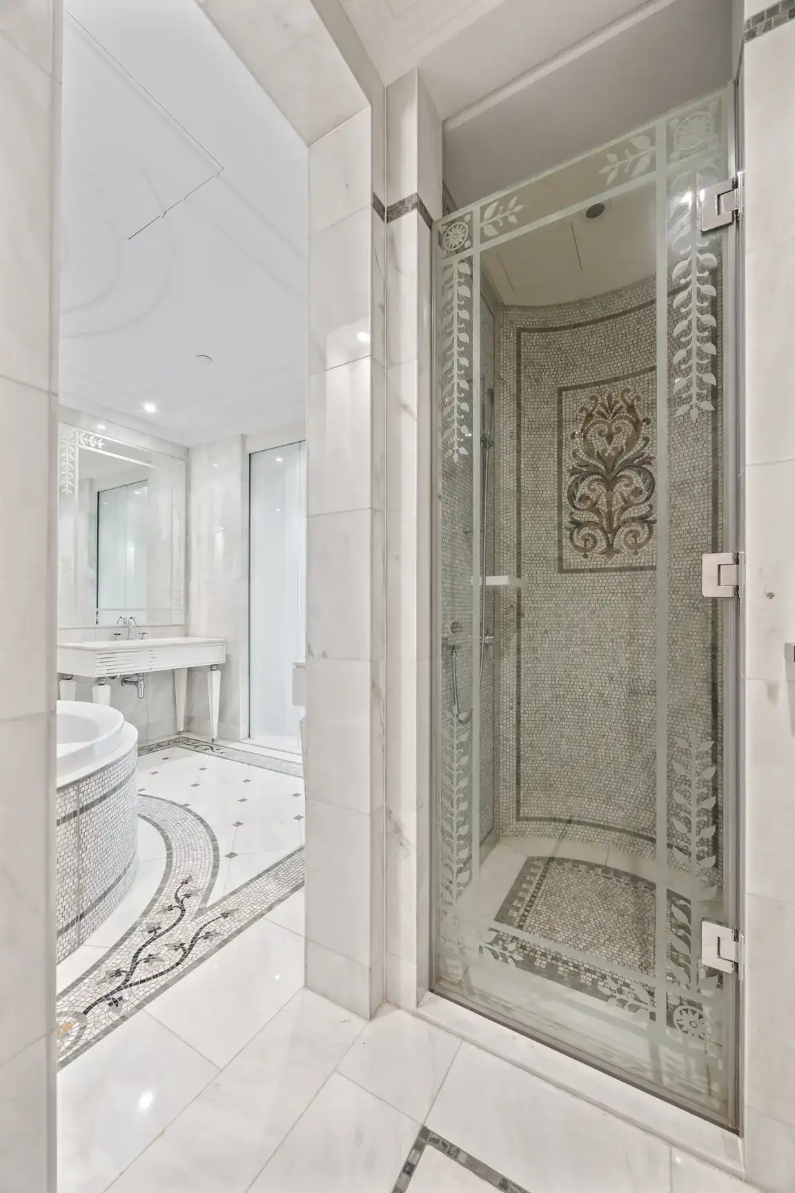 Glass shower enclosure with marble walls in a three-bedroom residence at Palazzo Versace Dubai, Jaddaf Waterfront, photographed for Concierge Auctions.