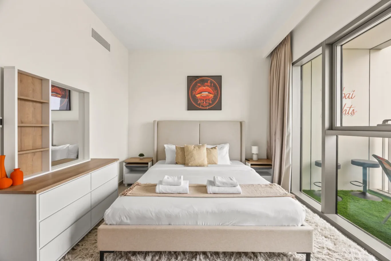 Master bedroom with fitted wardrobes and balcony access. Day, twilight and night Airbnb photography by MRPS for Vista Haus Holiday Homes in Downtown Dubai.