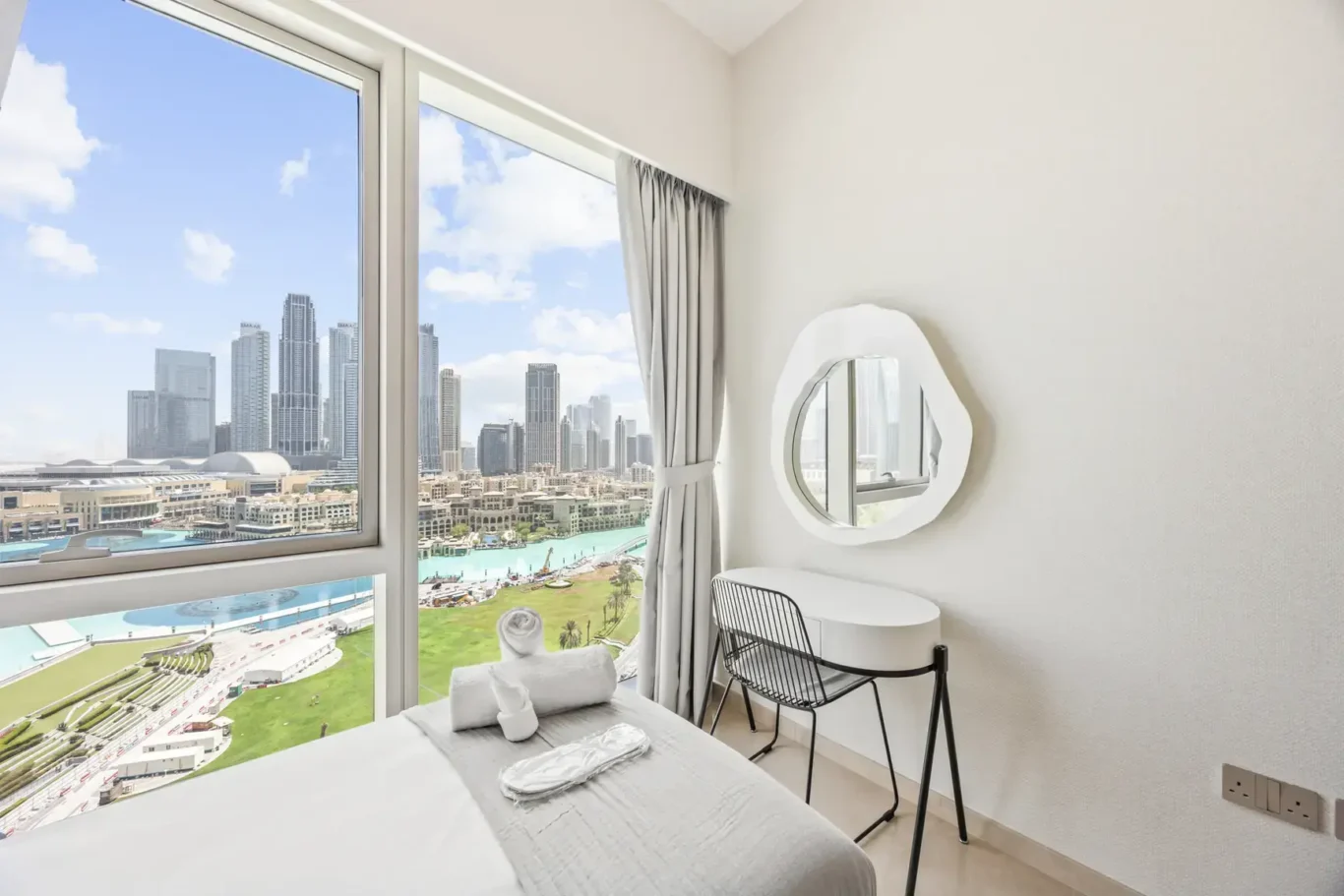 Bedroom with Dubai Fountain view in a two-bedroom StayComfy Holiday Homes apartment at Grande Signature, Downtown Dubai.