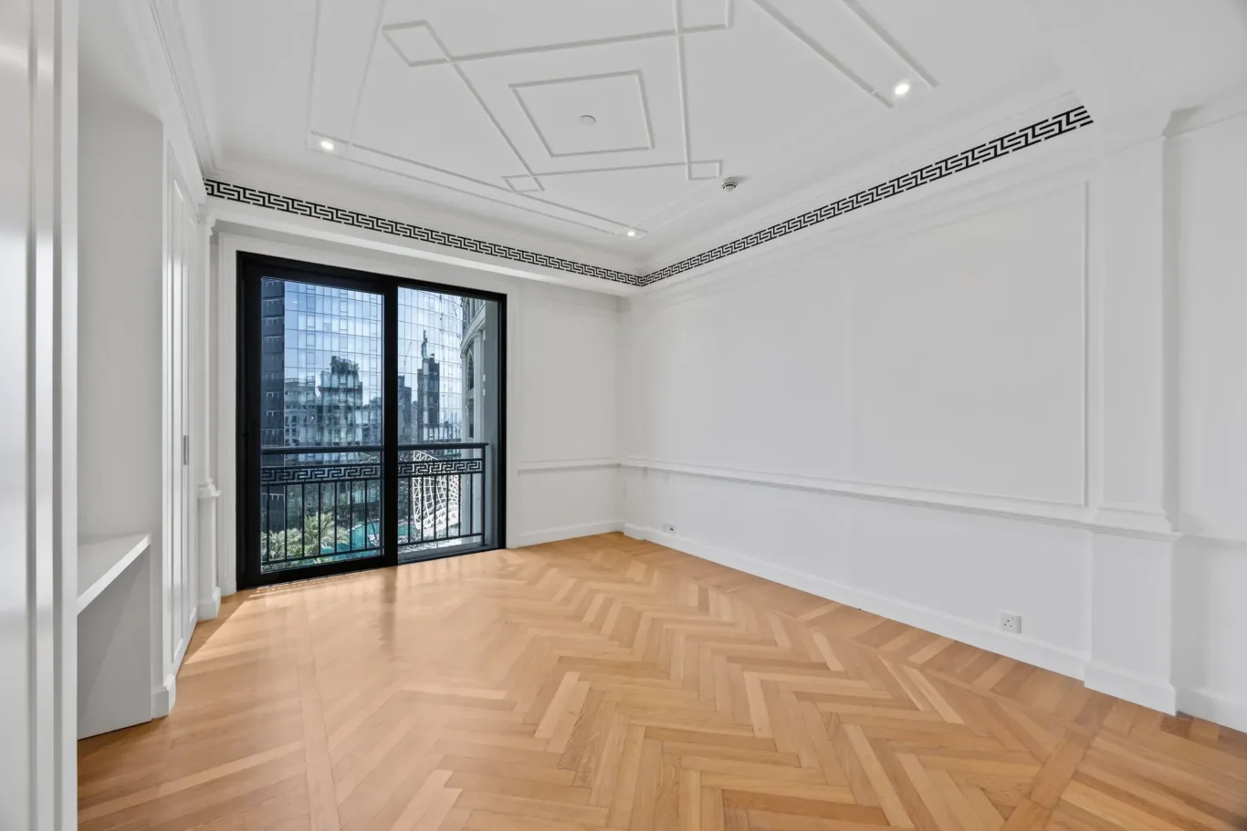 Bedroom with herringbone parquet and balcony door in a three-bedroom residence at Palazzo Versace Dubai, Jaddaf Waterfront, photographed for Concierge Auctions.