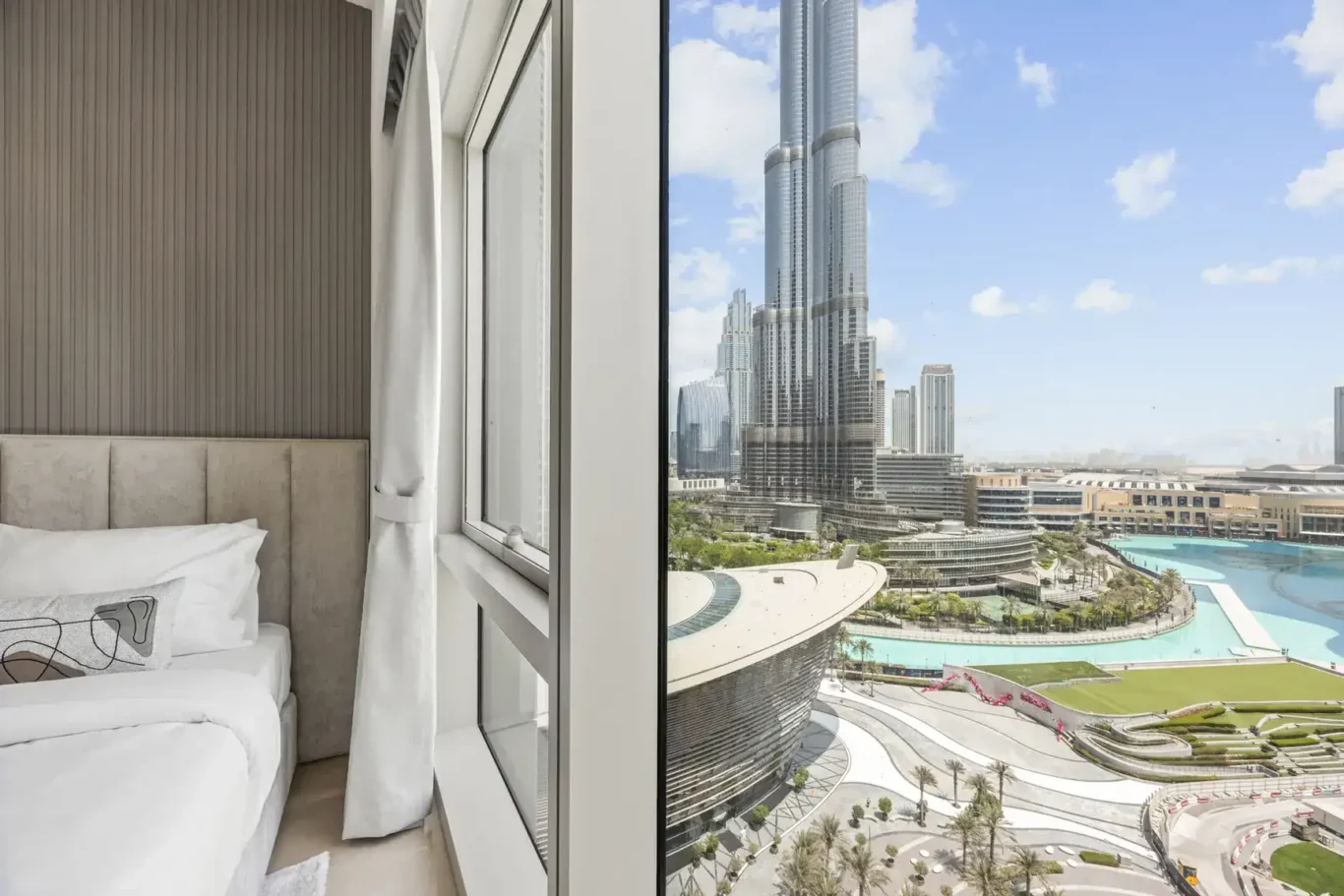 Bedroom window with Burj Khalifa view in a two-bedroom StayComfy Holiday Homes apartment at Grande Signature, Downtown Dubai.