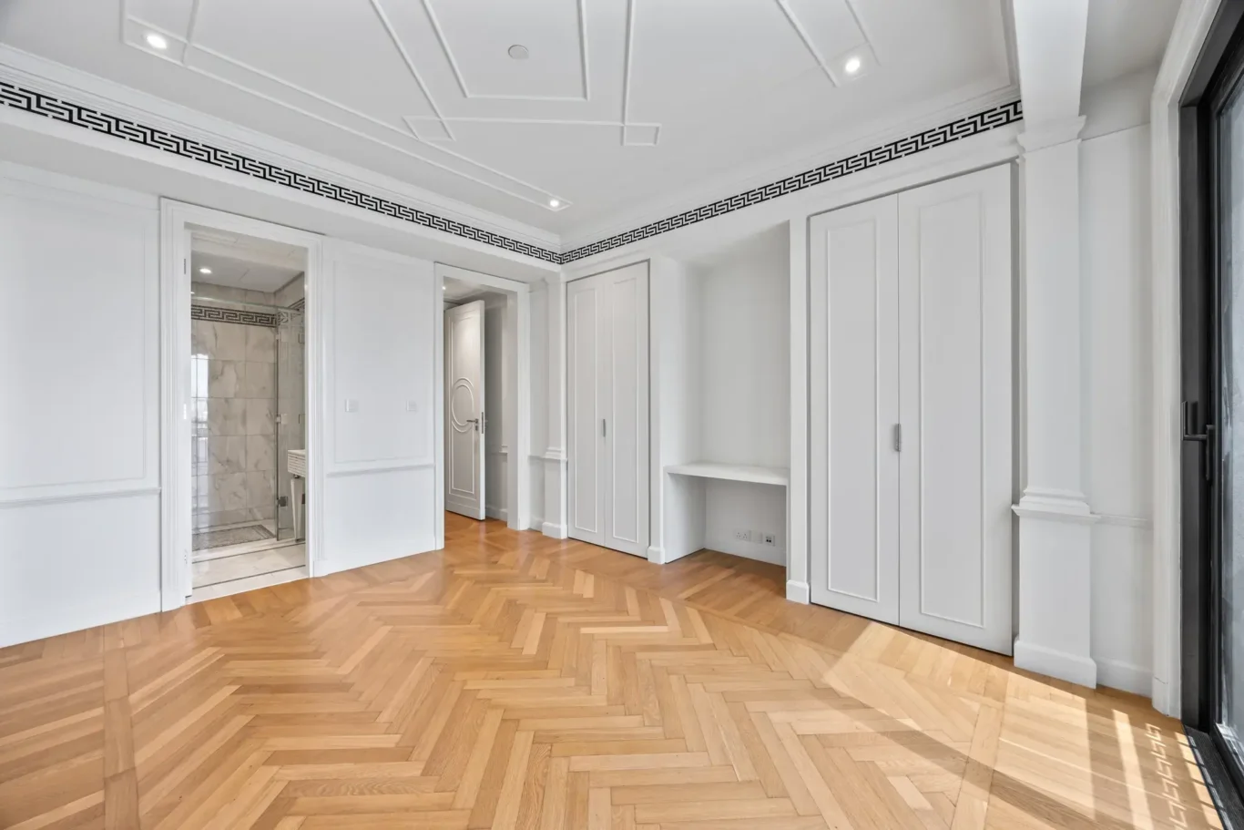 Bedroom with built-in wardrobes and en suite door in a three-bedroom residence at Palazzo Versace Dubai, Jaddaf Waterfront, photographed for Concierge Auctions.