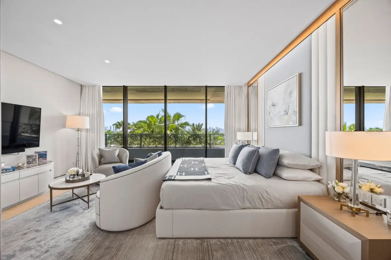 Master bedroom with king bed and sitting area in a furnished three-bedroom residence at Atlantis The Royal, Palm Jumeirah, photographed for Apex Homes Real Estate.
