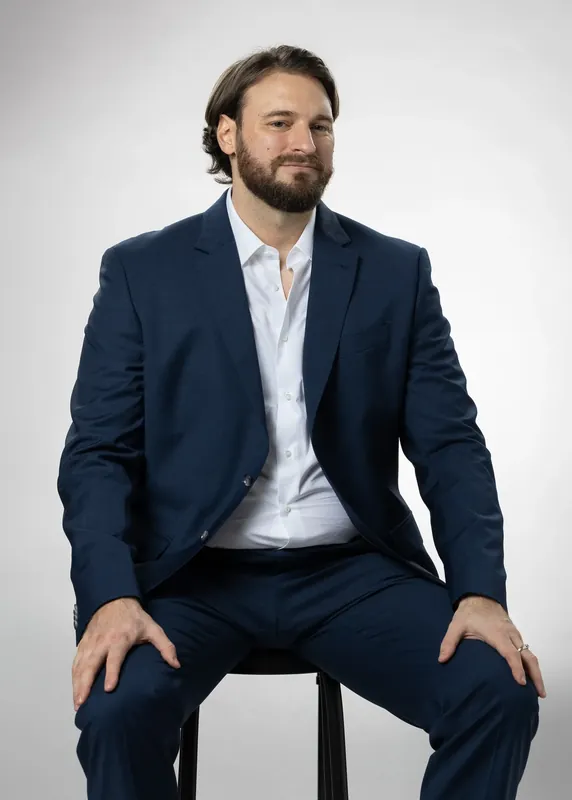 Seated pose with hands on knees. White background reference photo from an AI model training photoshoot at the MRPS studio in Dubai.