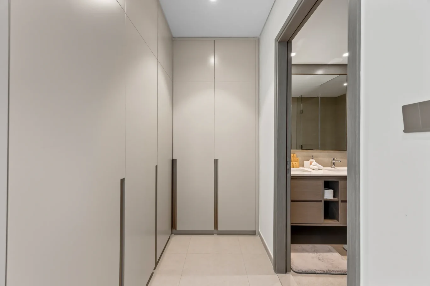 Built in wardrobe corridor leading to the ensuite bathroom. Airbnb photography by MRPS for Solea Stay in Dubai.