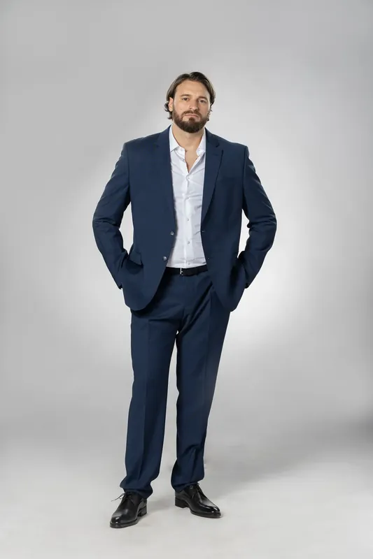 Full-body standing pose with hands in pockets. White background reference photo from an AI model training photoshoot at the MRPS studio in Dubai.