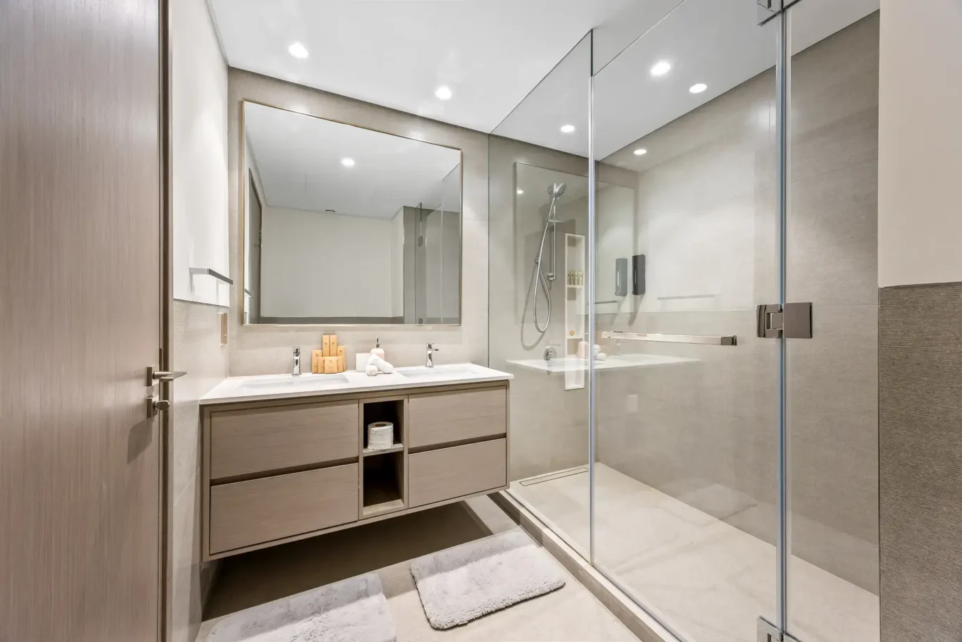 Master ensuite bathroom with glass shower and wooden vanity. Airbnb photography by MRPS for Solea Stay in Dubai.