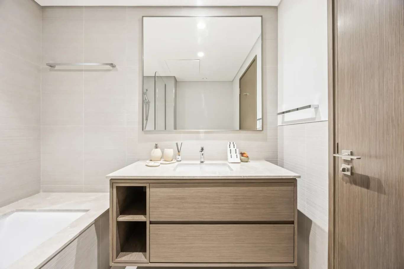 Bathroom vanity and bathtub in a two-bedroom StayComfy Holiday Homes apartment at Grande Signature, Downtown Dubai.