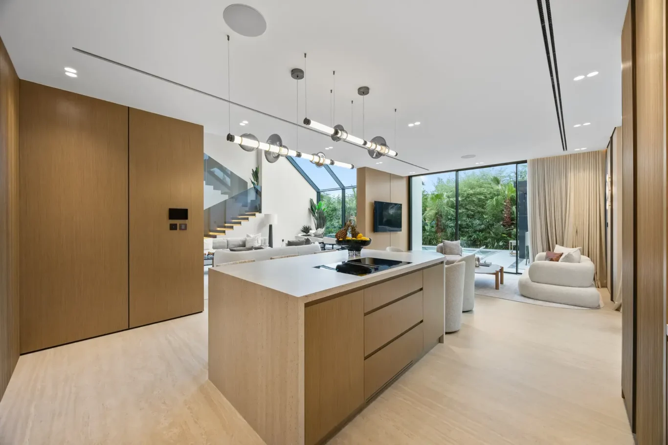 Kitchen island with wood cabinetry and a garden view, luxury villa in Jumeirah Islands, Dubai.
