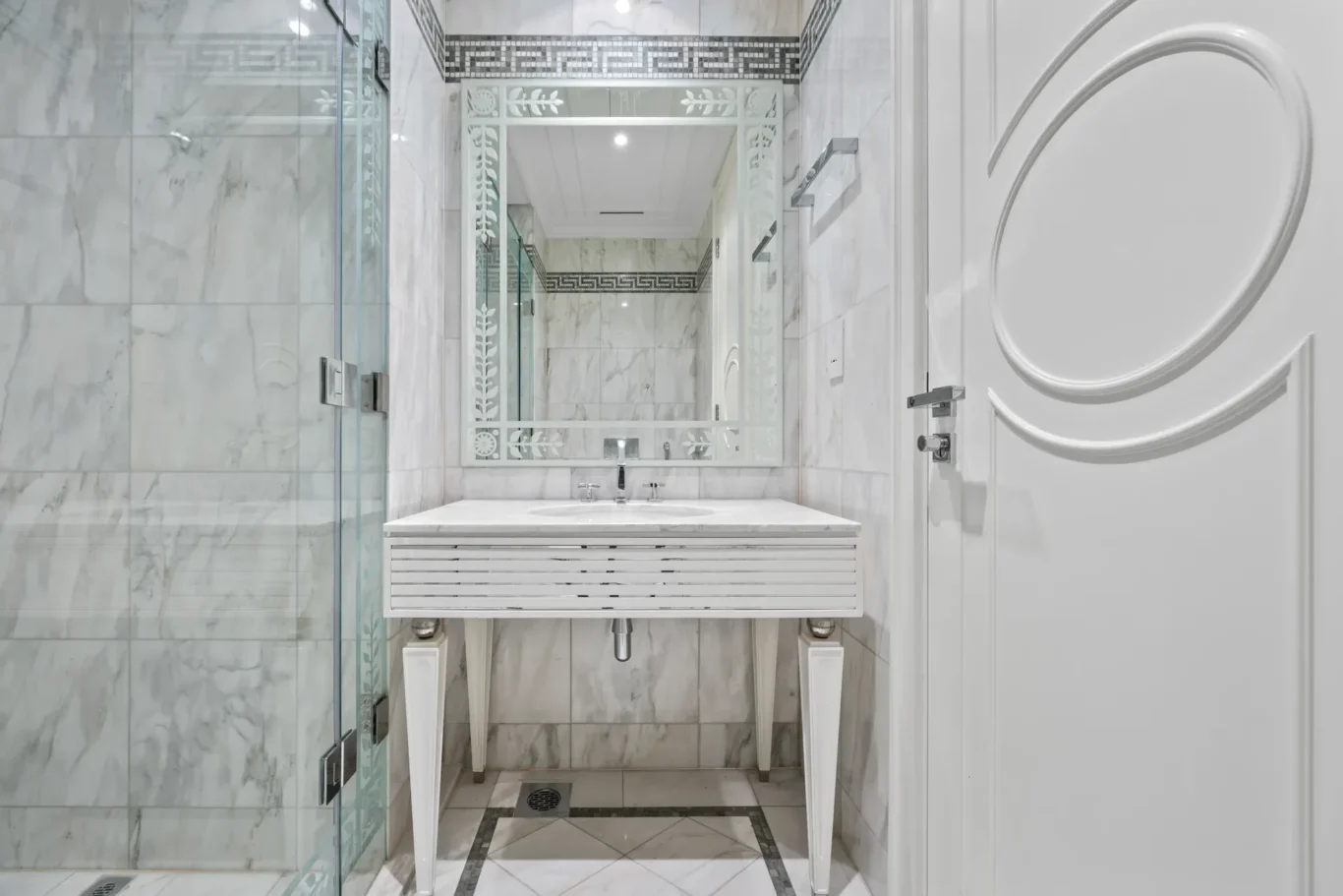En suite bathroom with marble vanity and glass shower in a three-bedroom residence at Palazzo Versace Dubai, Jaddaf Waterfront, photographed for Concierge Auctions.