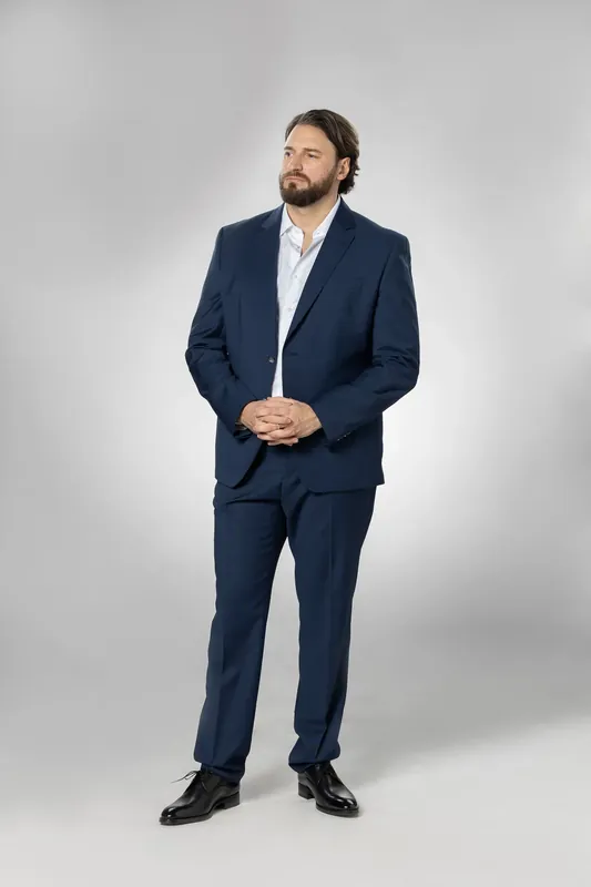 Full-body standing pose with hands together. White background reference photo from an AI model training photoshoot at the MRPS studio in Dubai.