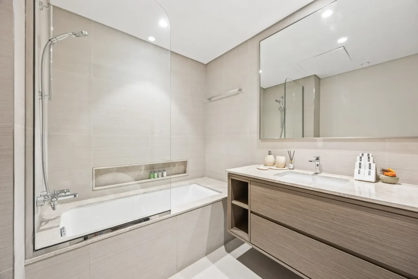 Bathroom with bathtub in a two-bedroom StayComfy Holiday Homes apartment at Grande Signature, Downtown Dubai.