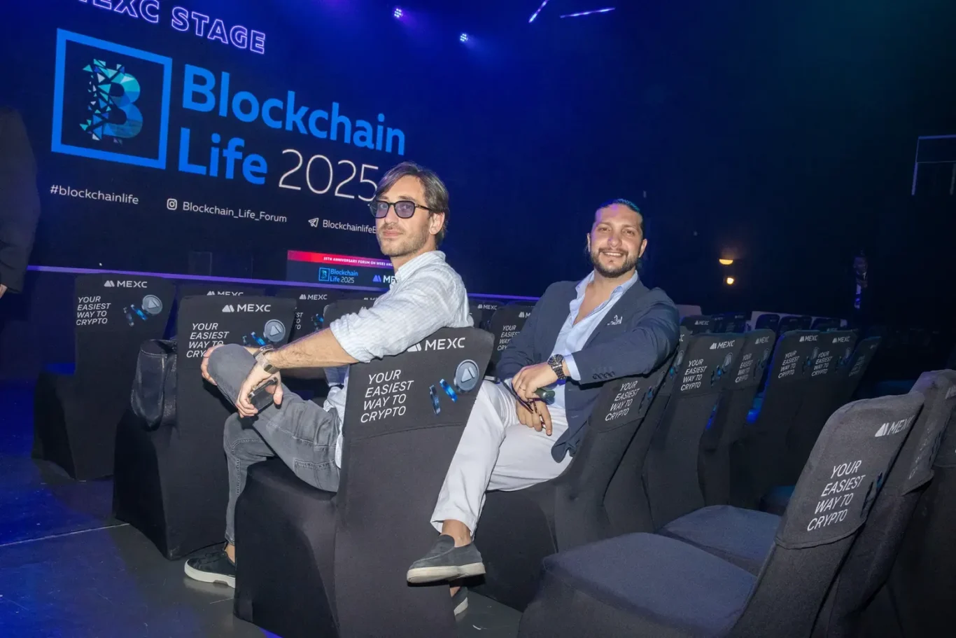 Guests relaxing in the arena VIP seating. Event photography by MRPS at Blockchain Life 2025, Festival Arena, Dubai.