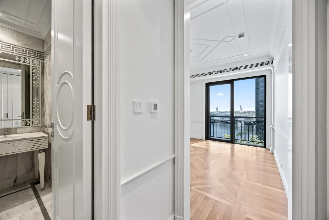 Bedroom with en suite bathroom and balcony in a three-bedroom residence at Palazzo Versace Dubai, Jaddaf Waterfront, photographed for Concierge Auctions.