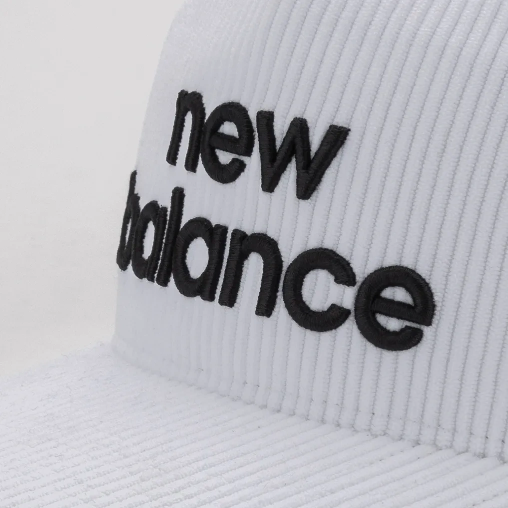 Close-up of the black logo on the white corduroy New Balance cap. E-commerce product photography for New Balance by MRPS in Dubai.