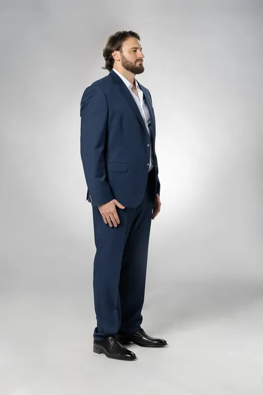 Full-body side view. White background reference photo from an AI model training photoshoot at the MRPS studio in Dubai.