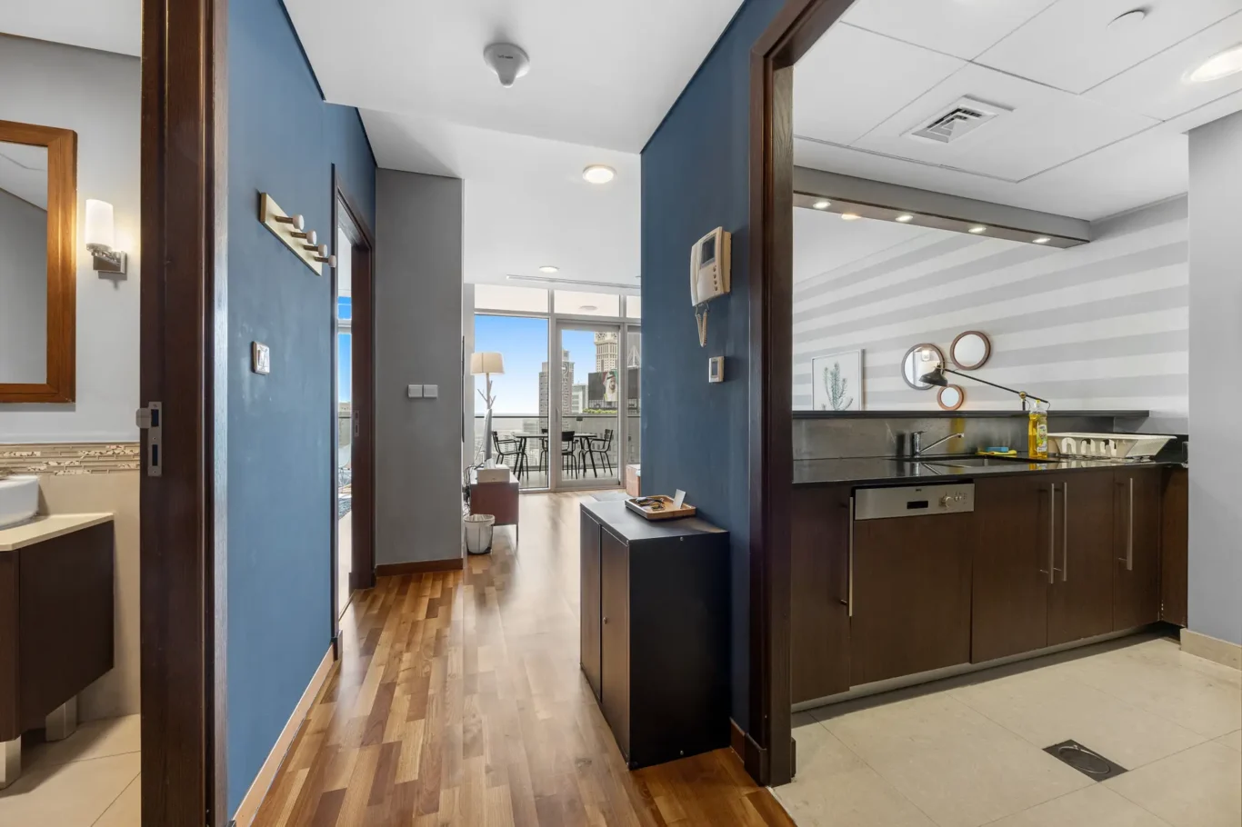 Hallway with the kitchen on the right in a Your Stay Apartments one-bedroom at Burj Daman, DIFC, Dubai.