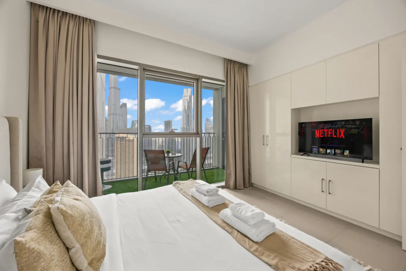 King bed beside the window with the Burj Khalifa behind. Day, twilight and night Airbnb photography by MRPS for Vista Haus Holiday Homes in Downtown Dubai.