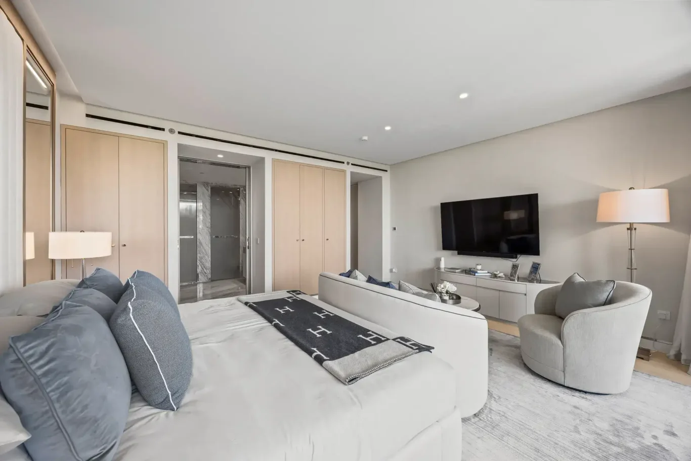 Master bedroom with built-in wardrobes in a furnished three-bedroom residence at Atlantis The Royal, Palm Jumeirah, photographed for Apex Homes Real Estate.