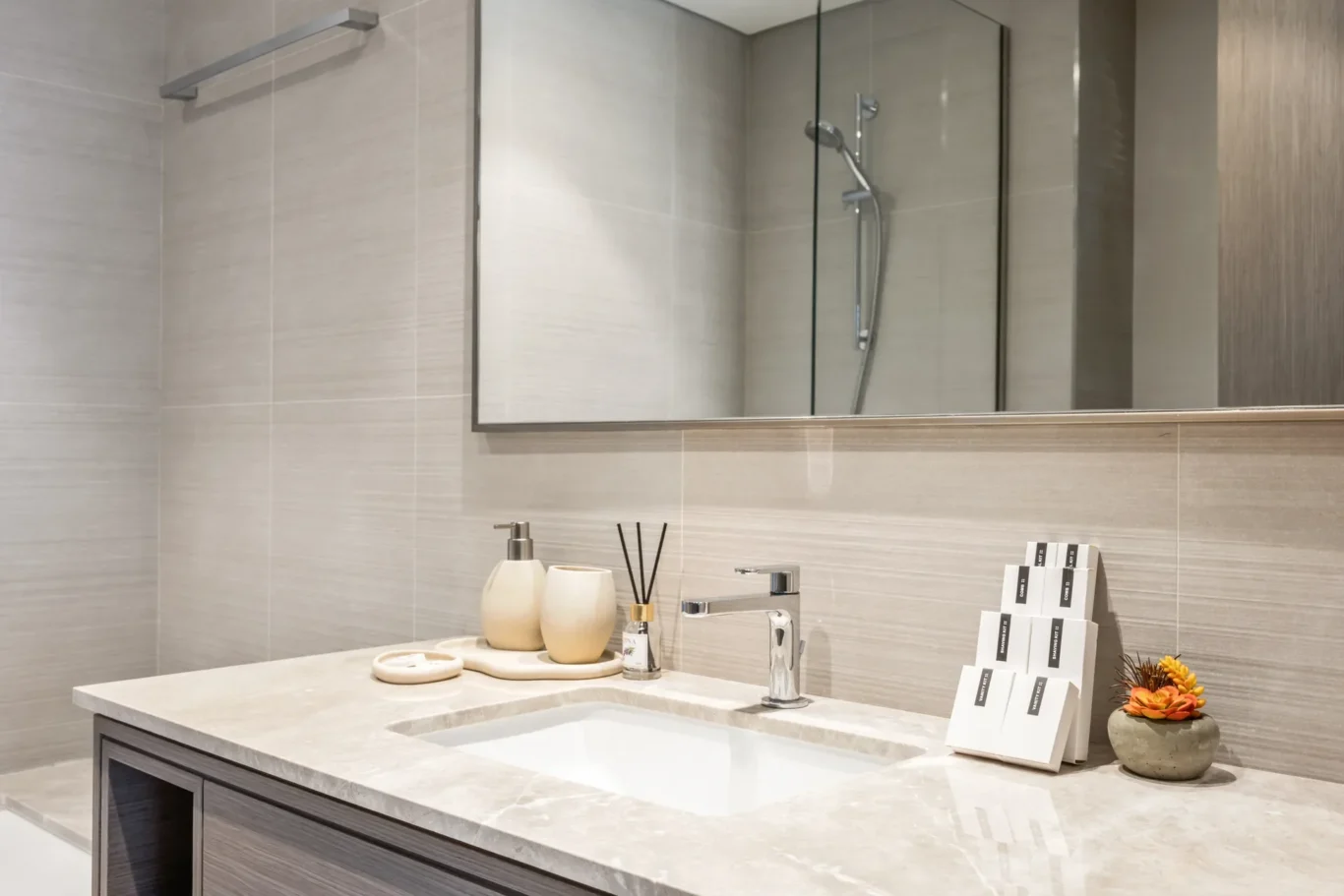 Bathroom vanity with guest amenities in a two-bedroom StayComfy Holiday Homes apartment at Grande Signature, Downtown Dubai.