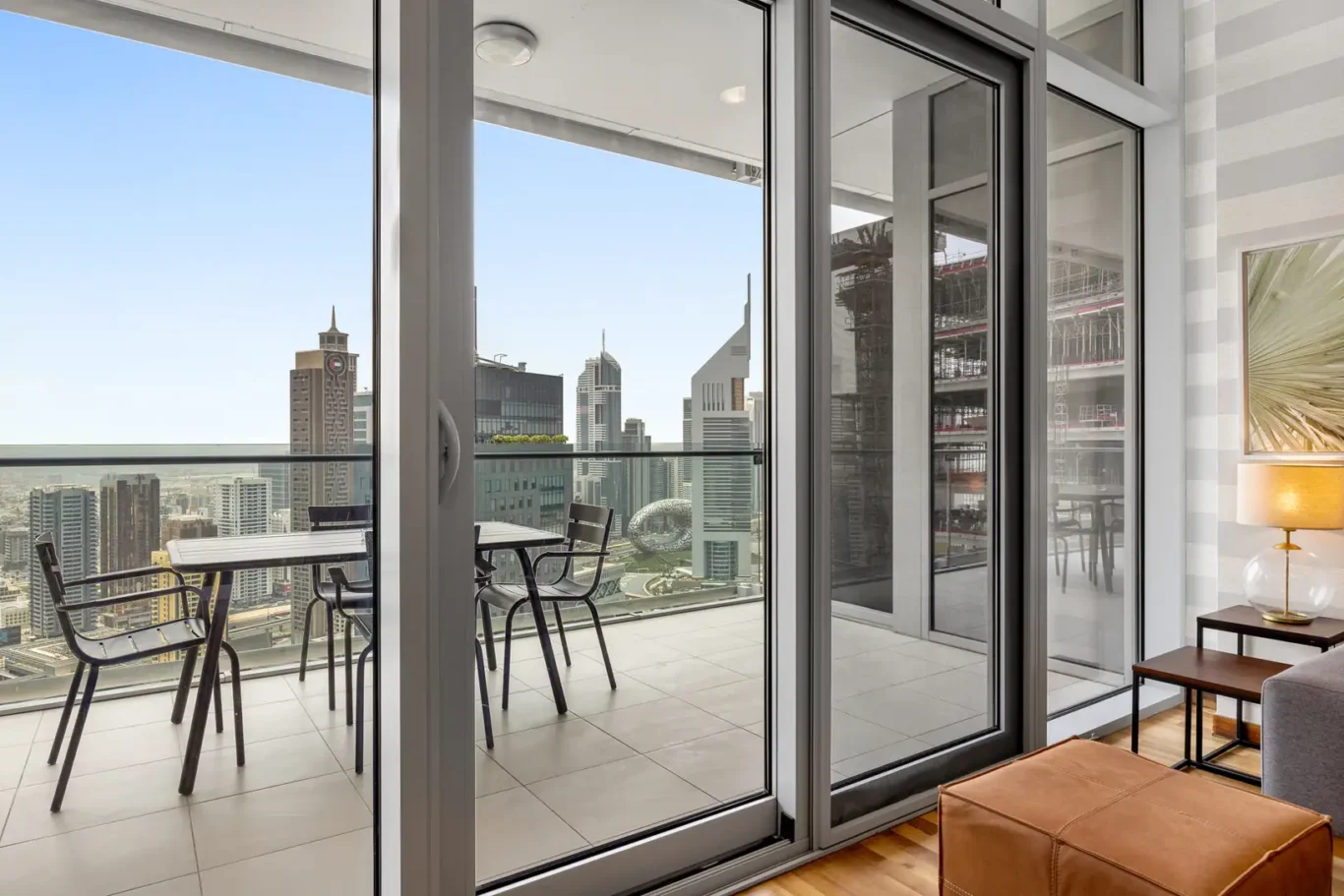 Balcony with seating and DIFC tower views in a Your Stay Apartments one-bedroom at Burj Daman, DIFC, Dubai.