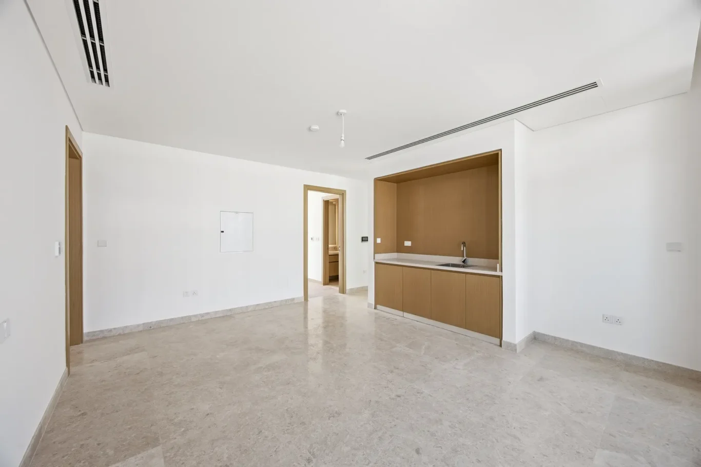 Family room with marble floor and sliding doors to the terrace. Villa photography by MRPS in Dubai for ELITE Property Brokerage.