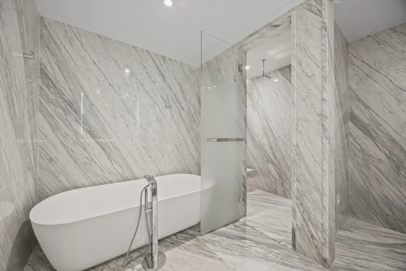 Freestanding bathtub and walk-in shower in the master bathroom in a furnished three-bedroom residence at Atlantis The Royal, Palm Jumeirah, photographed for Apex Homes Real Estate.