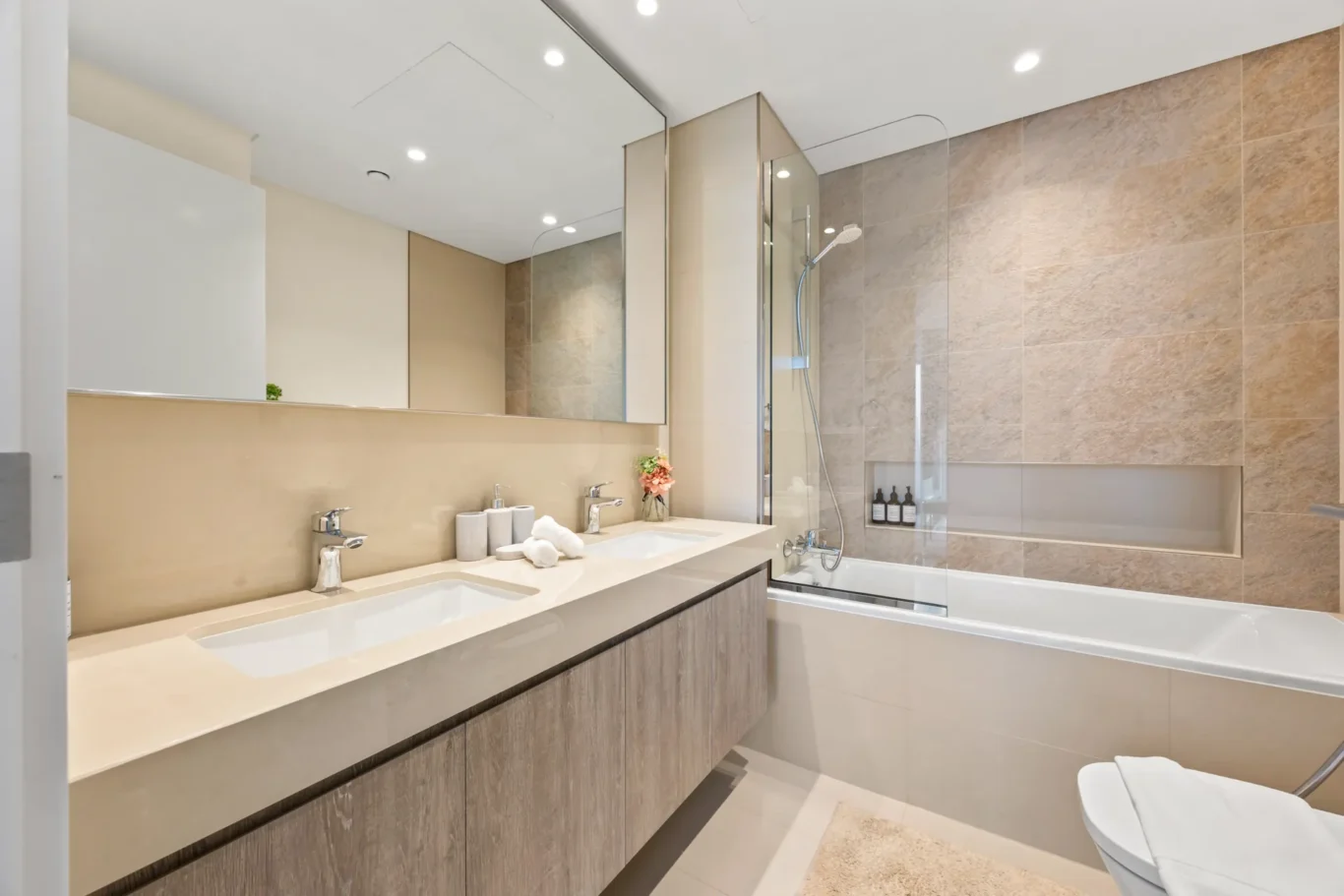 Second bathroom with long vanity, mirror and bathtub. Day, twilight and night Airbnb photography by MRPS for Vista Haus Holiday Homes in Downtown Dubai.