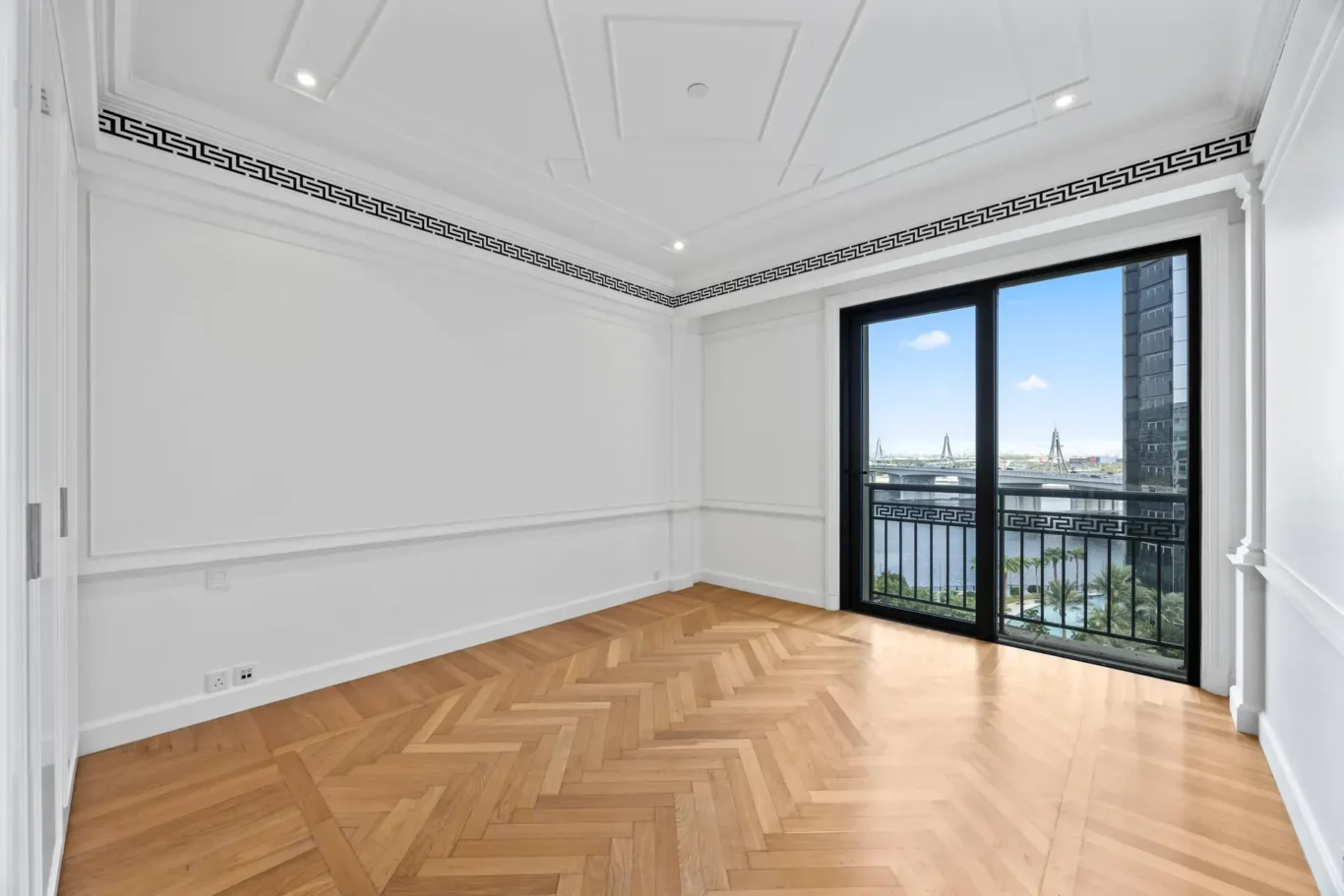 Bedroom with balcony door and Greek key cornice in a three-bedroom residence at Palazzo Versace Dubai, Jaddaf Waterfront, photographed for Concierge Auctions.