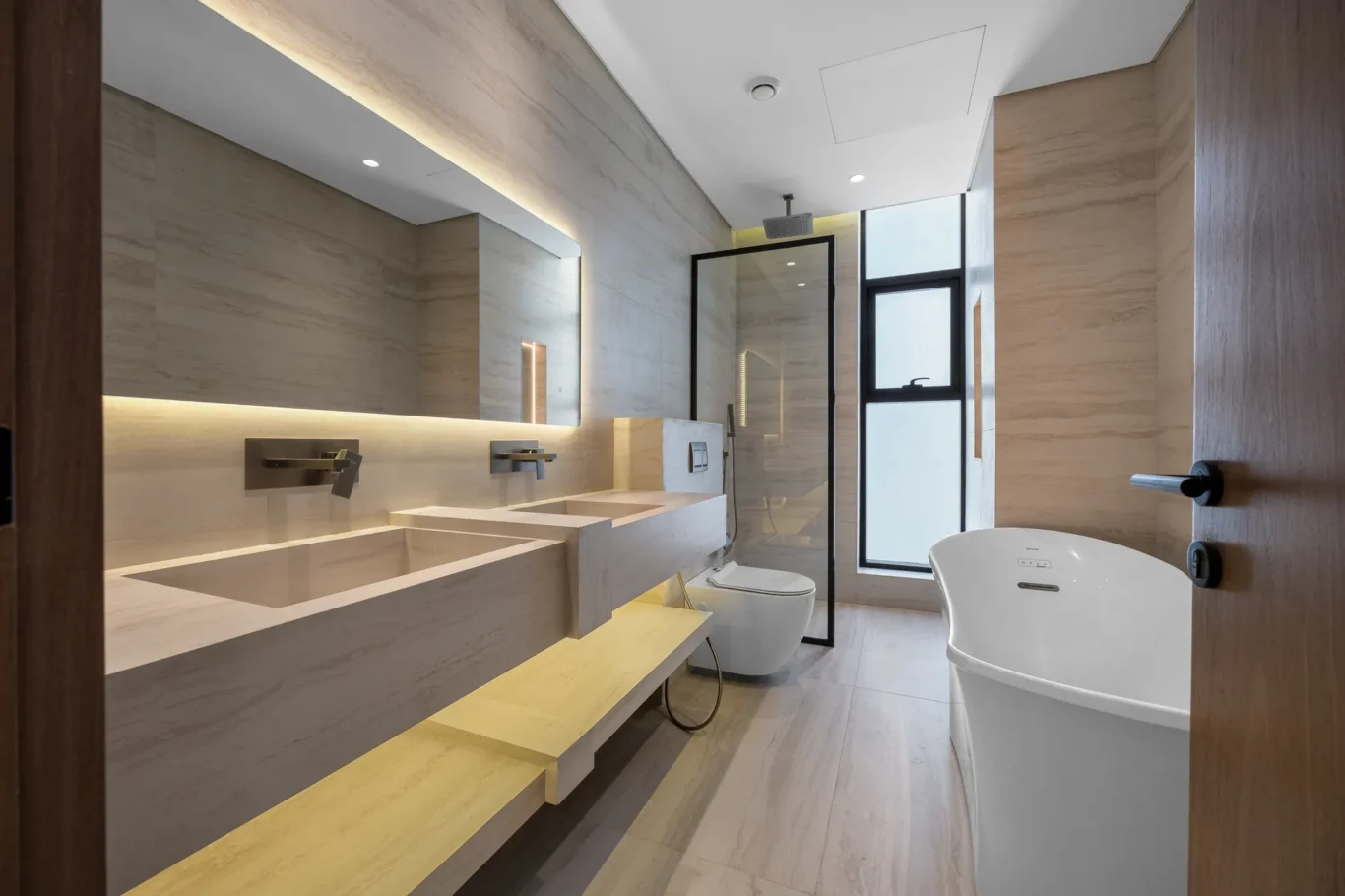 Master bathroom with a double vanity and freestanding bathtub, unfurnished five-bedroom villa in Al Furjan, Dubai.
