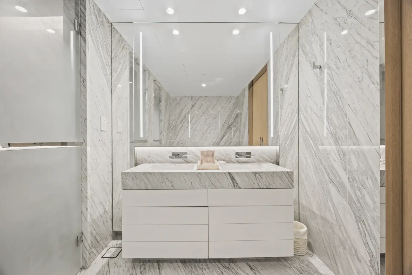 Master bathroom vanity with backlit mirror in a furnished three-bedroom residence at Atlantis The Royal, Palm Jumeirah, photographed for Apex Homes Real Estate.