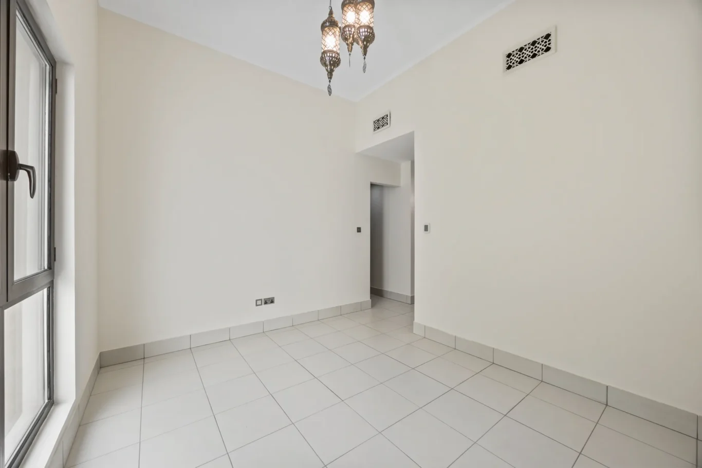 Second bedroom with built-in wardrobe door in an unfurnished two-bedroom garden apartment in Old Town, Downtown Dubai, photographed for ELITE Property Brokerage.