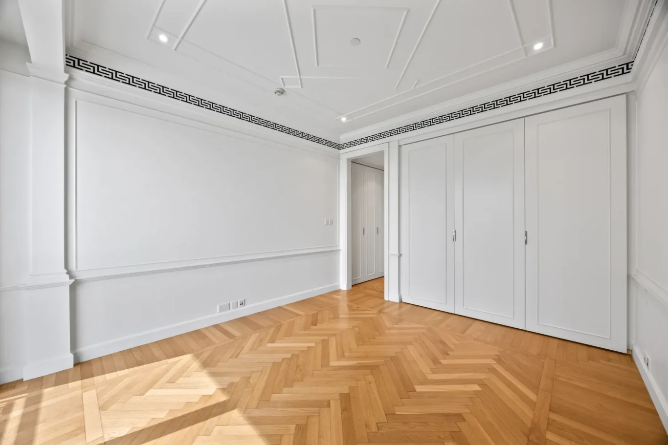 Bedroom with herringbone parquet floor in a three-bedroom residence at Palazzo Versace Dubai, Jaddaf Waterfront, photographed for Concierge Auctions.