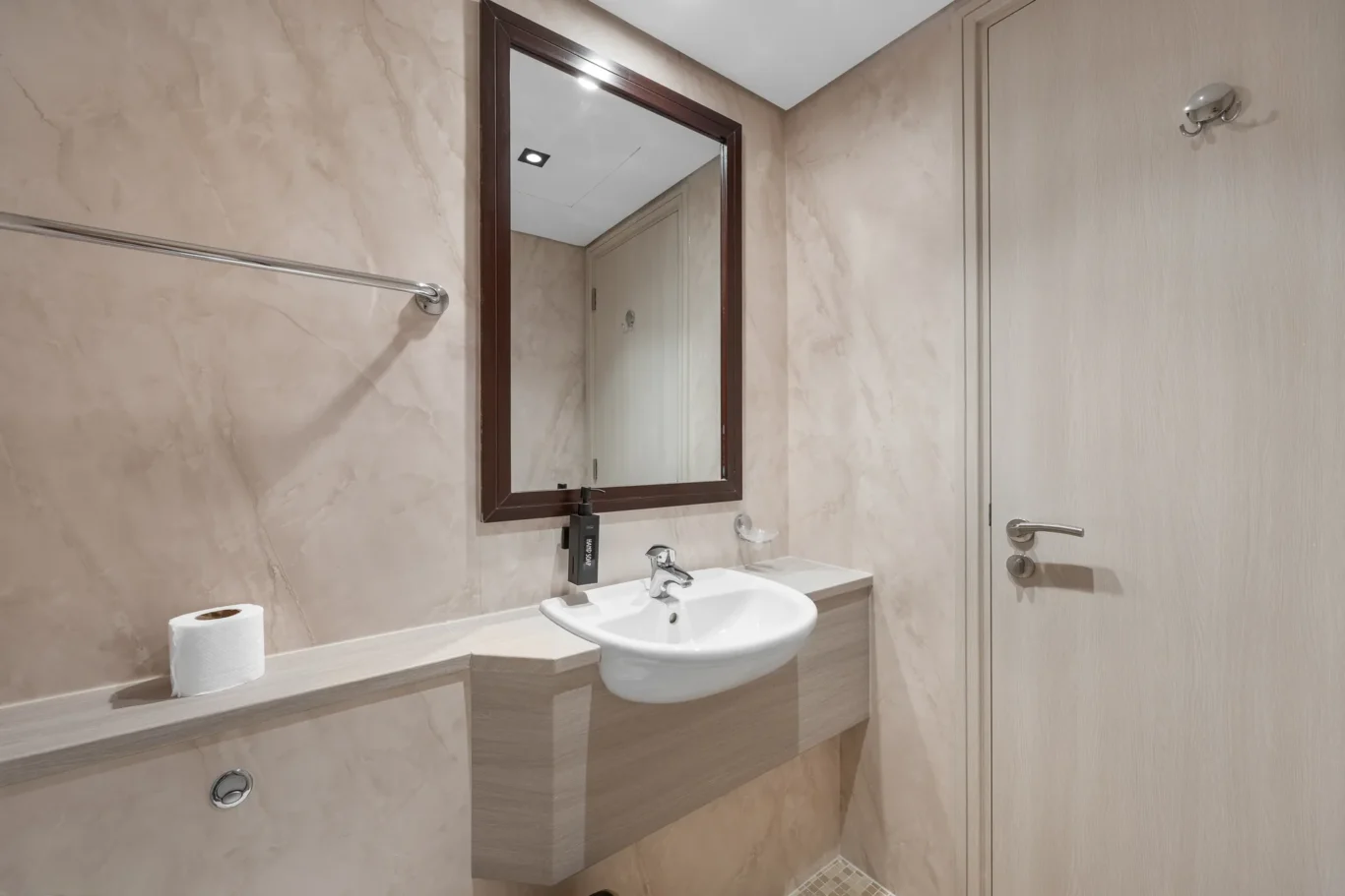 Guest washroom in a Your Stay Apartments one-bedroom at Sky Gardens, DIFC, Dubai.