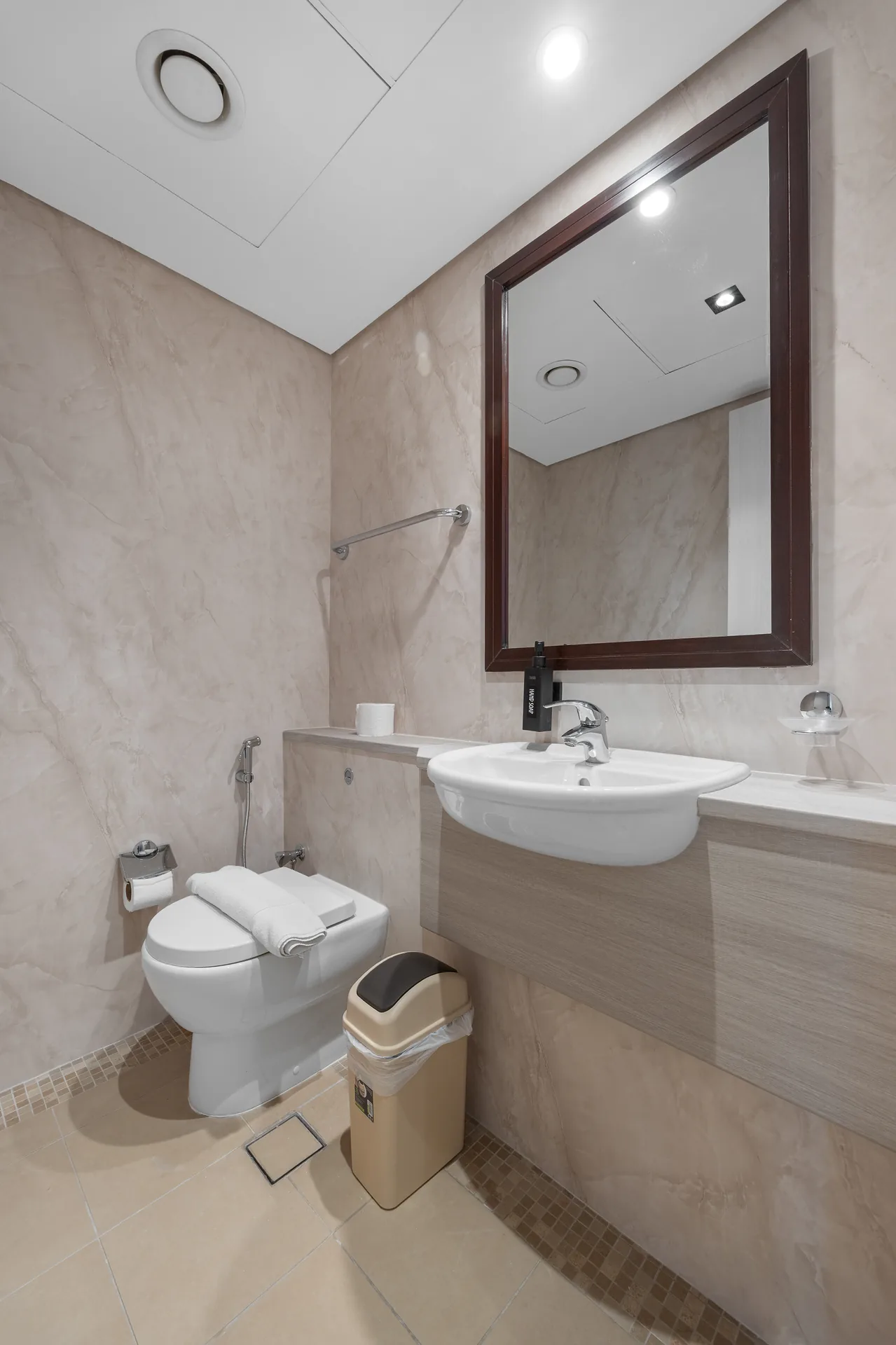 Guest toilet and basin in a Your Stay Apartments one-bedroom at Sky Gardens, DIFC, Dubai.