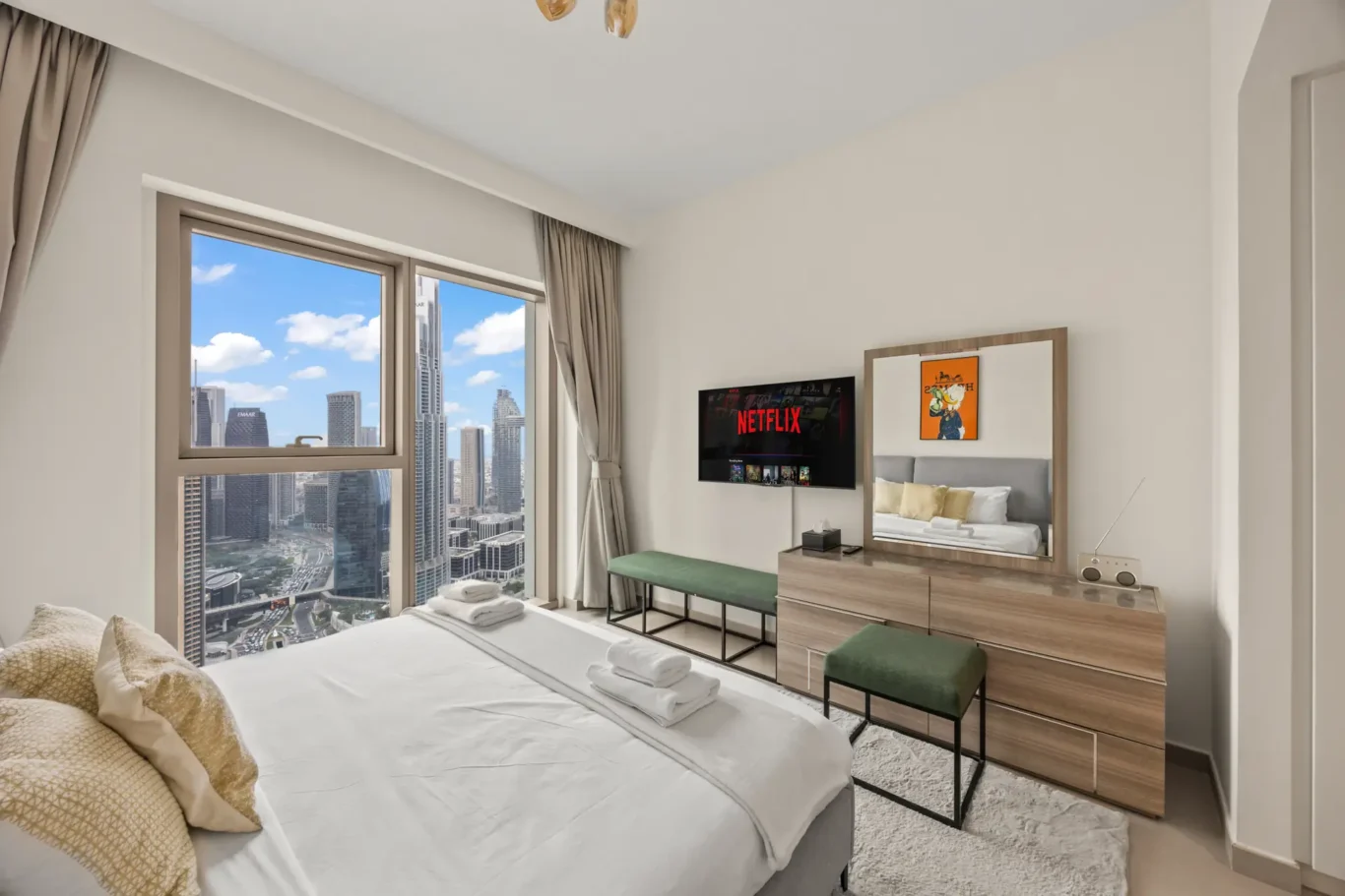 Second bedroom with bed, window and skyline view. Day, twilight and night Airbnb photography by MRPS for Vista Haus Holiday Homes in Downtown Dubai.