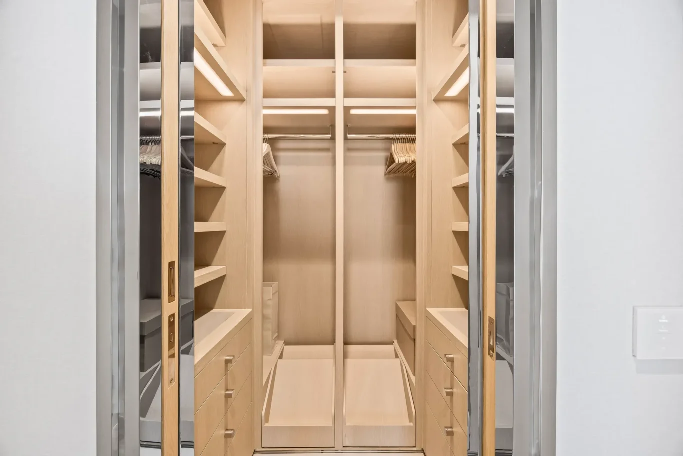 Walk-in wardrobe with open shelving in a furnished three-bedroom residence at Atlantis The Royal, Palm Jumeirah, photographed for Apex Homes Real Estate.