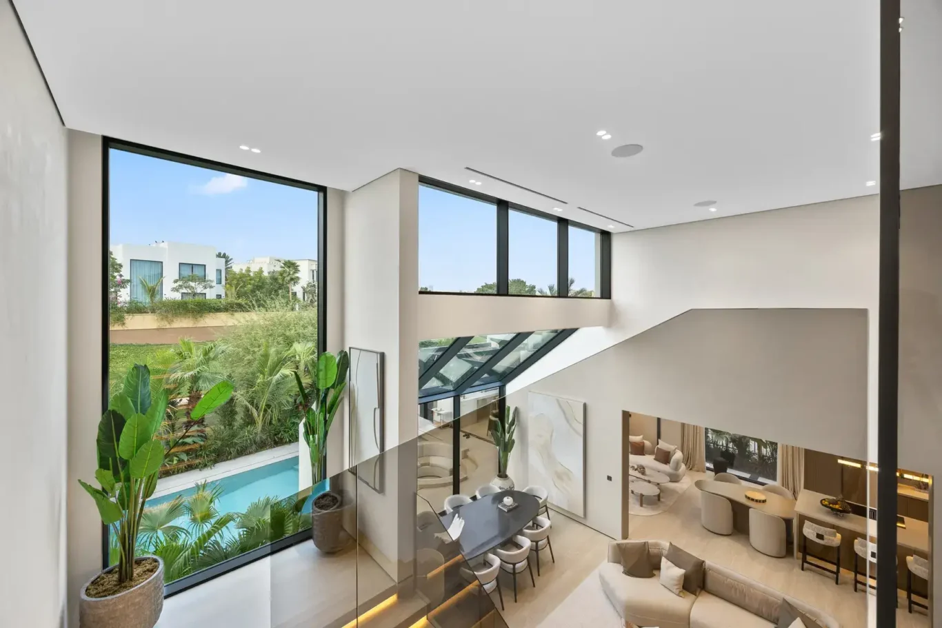 Mezzanine view down to the dining area and pool, luxury villa in Jumeirah Islands, Dubai.
