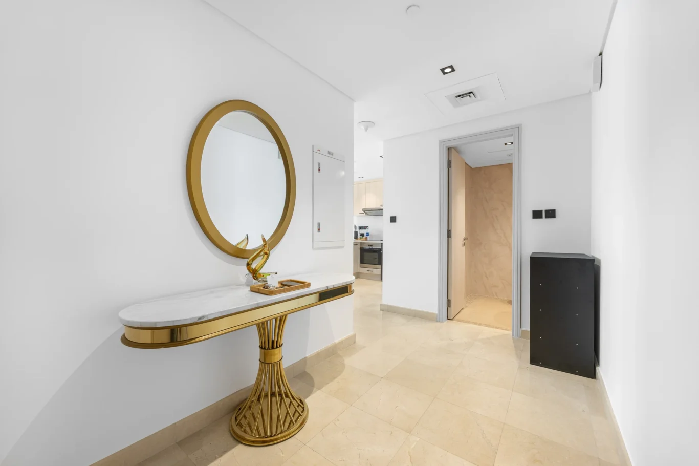Entrance console and oval mirror in a Your Stay Apartments one-bedroom at Sky Gardens, DIFC, Dubai.