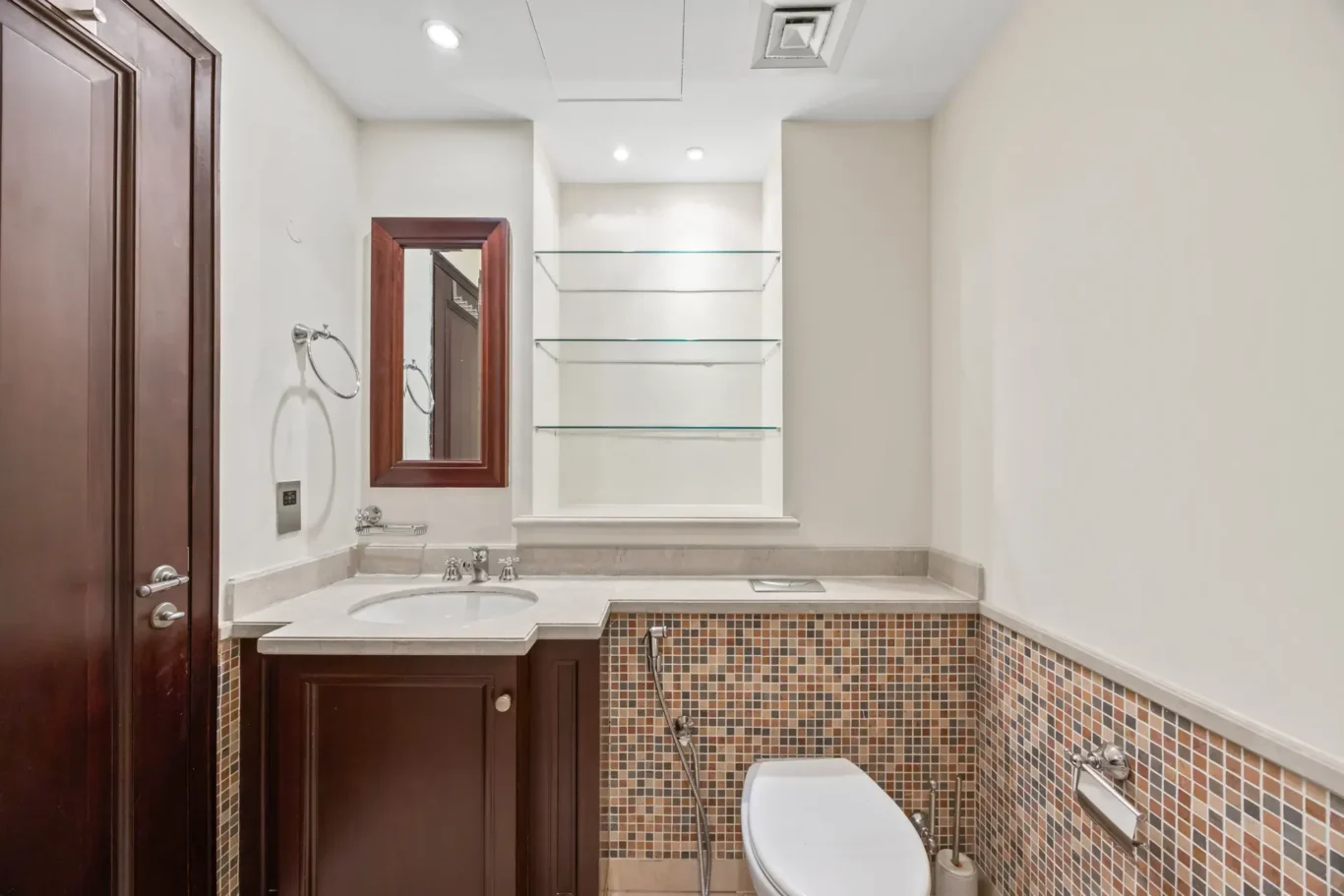 Master bathroom vanity with glass shelves in an unfurnished two-bedroom garden apartment in Old Town, Downtown Dubai, photographed for ELITE Property Brokerage.