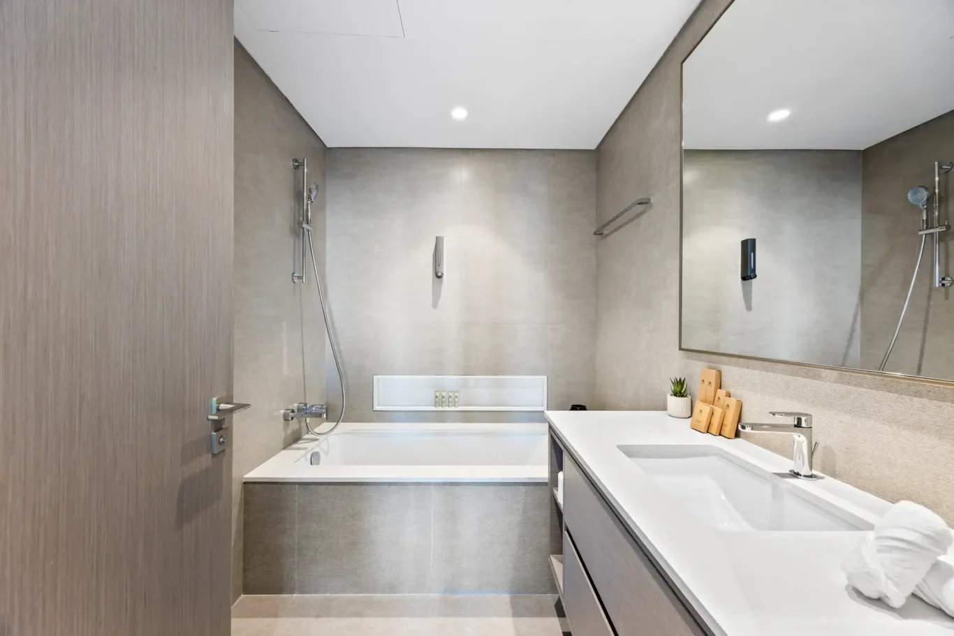 Second bathroom with bathtub and modern vanity. Airbnb photography by MRPS for Solea Stay in Dubai.