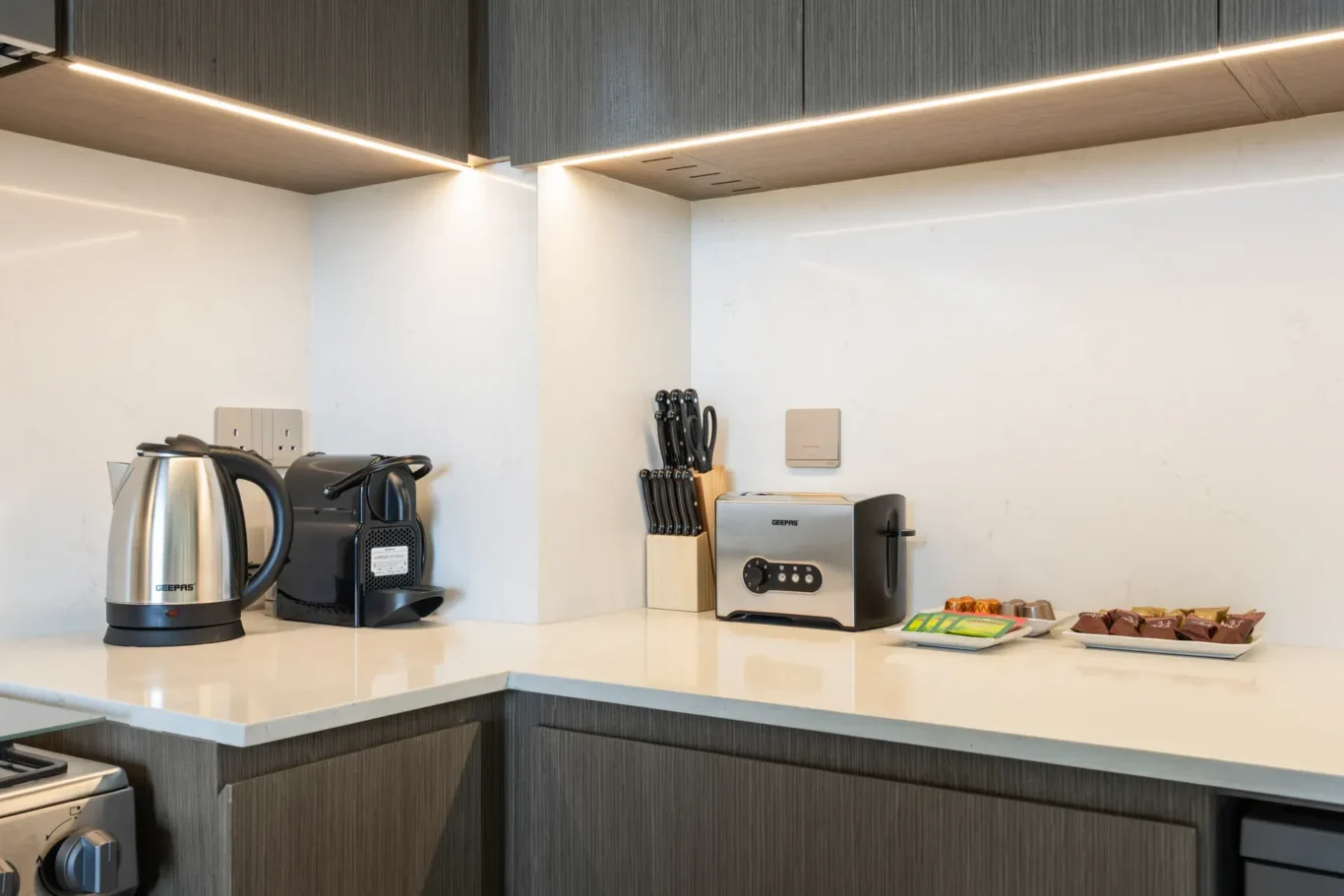 Kitchen coffee and tea station in a two-bedroom StayComfy Holiday Homes apartment at Grande Signature, Downtown Dubai.