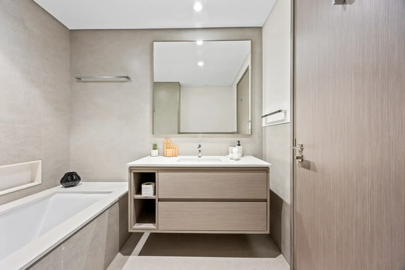 Bathroom vanity with large mirror beside the bathtub. Airbnb photography by MRPS for Solea Stay in Dubai.