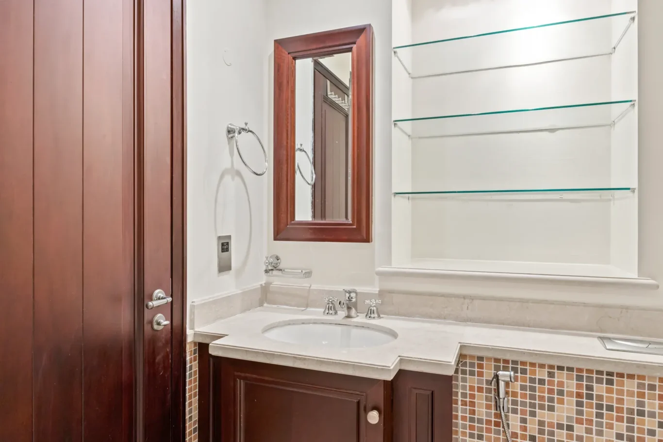 Bathroom vanity with framed mirror in an unfurnished two-bedroom garden apartment in Old Town, Downtown Dubai, photographed for ELITE Property Brokerage.