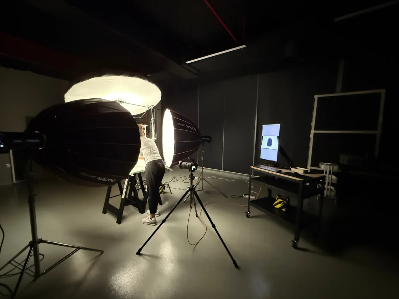 Tethered shooting with a live preview of a New Balance backpack on the monitor. Behind the scenes of the New Balance e-commerce product photography by MRPS in Dubai.