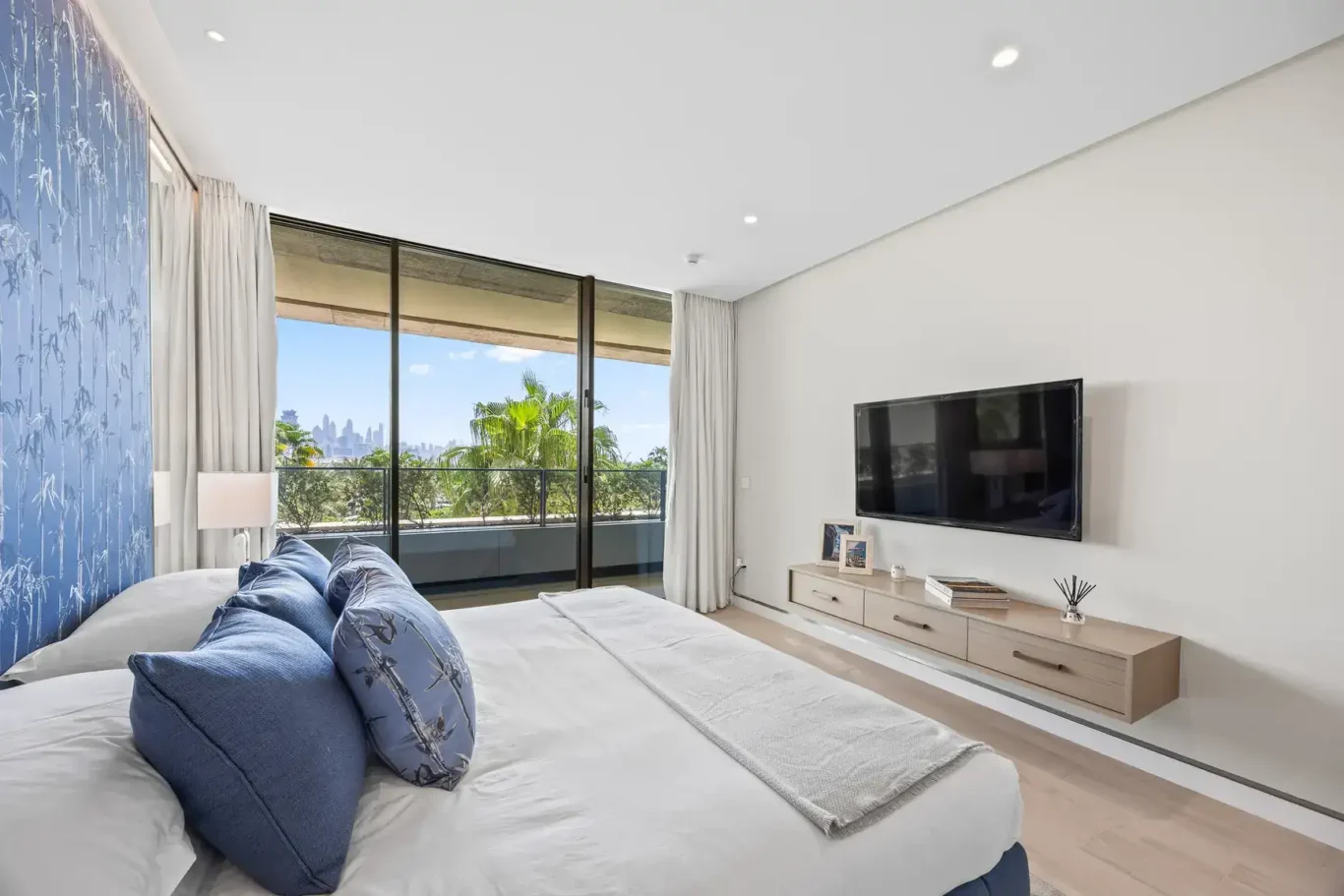 Blue bedroom with garden view in a furnished three-bedroom residence at Atlantis The Royal, Palm Jumeirah, photographed for Apex Homes Real Estate.
