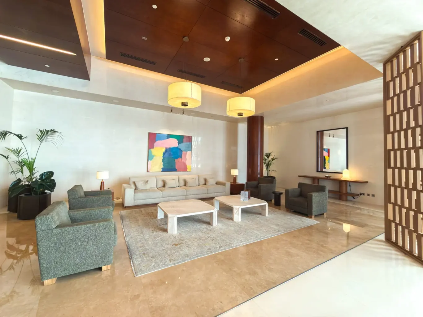 Lobby lounge with artwork and sofas at Burj Daman, DIFC, photographed for Your Stay Apartments.